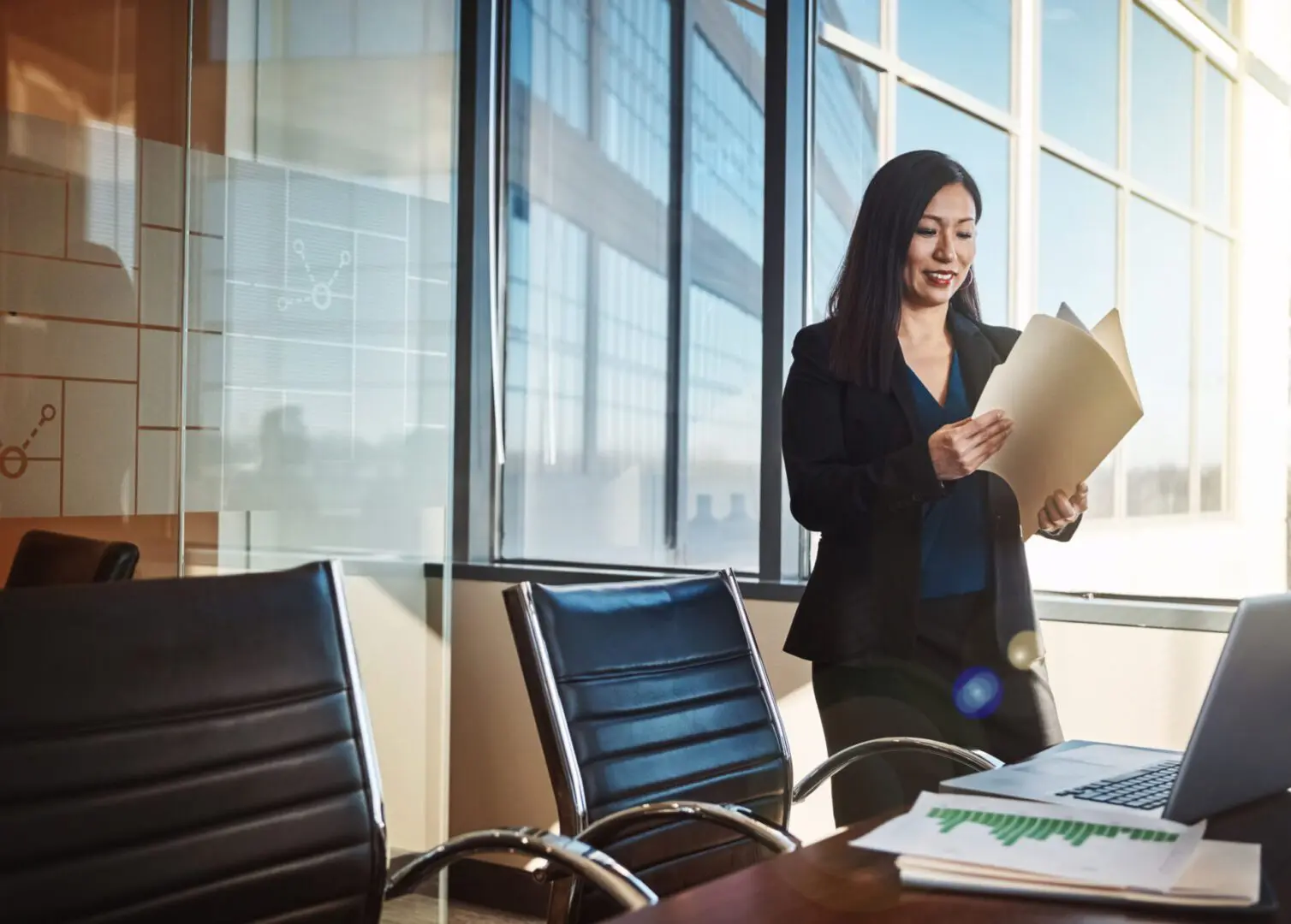 Businesswoman reviewing documents in modern office.
